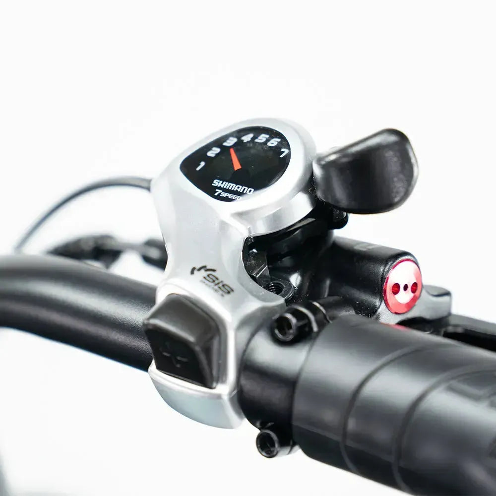 Close-up of a Ebike handlebar with Shimano gear shifter and SIS brand indicator on a white background