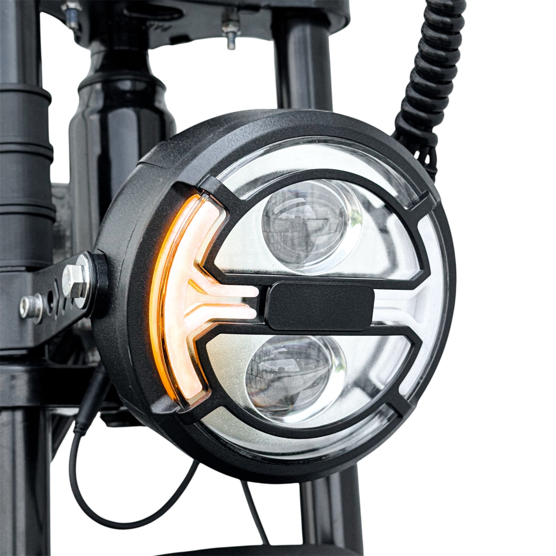 Close-up of a motorcycle headlight with visible signal indicator light on a white background