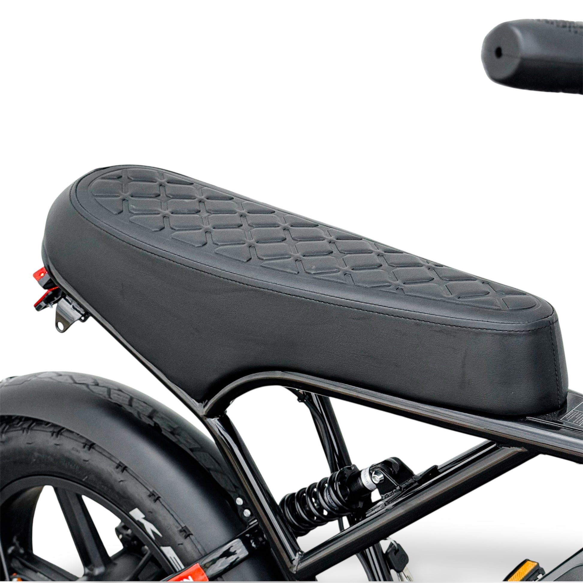 Close-up of a black ebike's seat motorcycle style with a textured surface on a white background